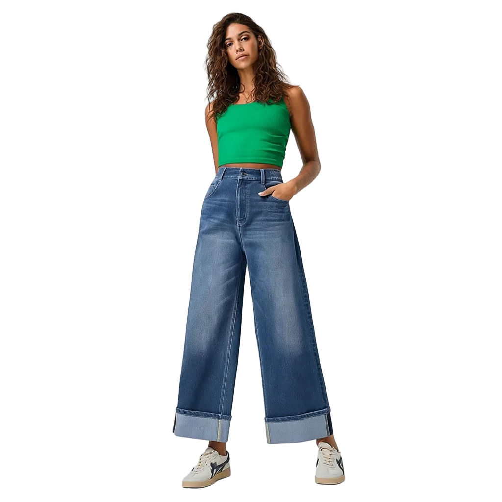 Woman wearing a green top and blue jeans on a white background