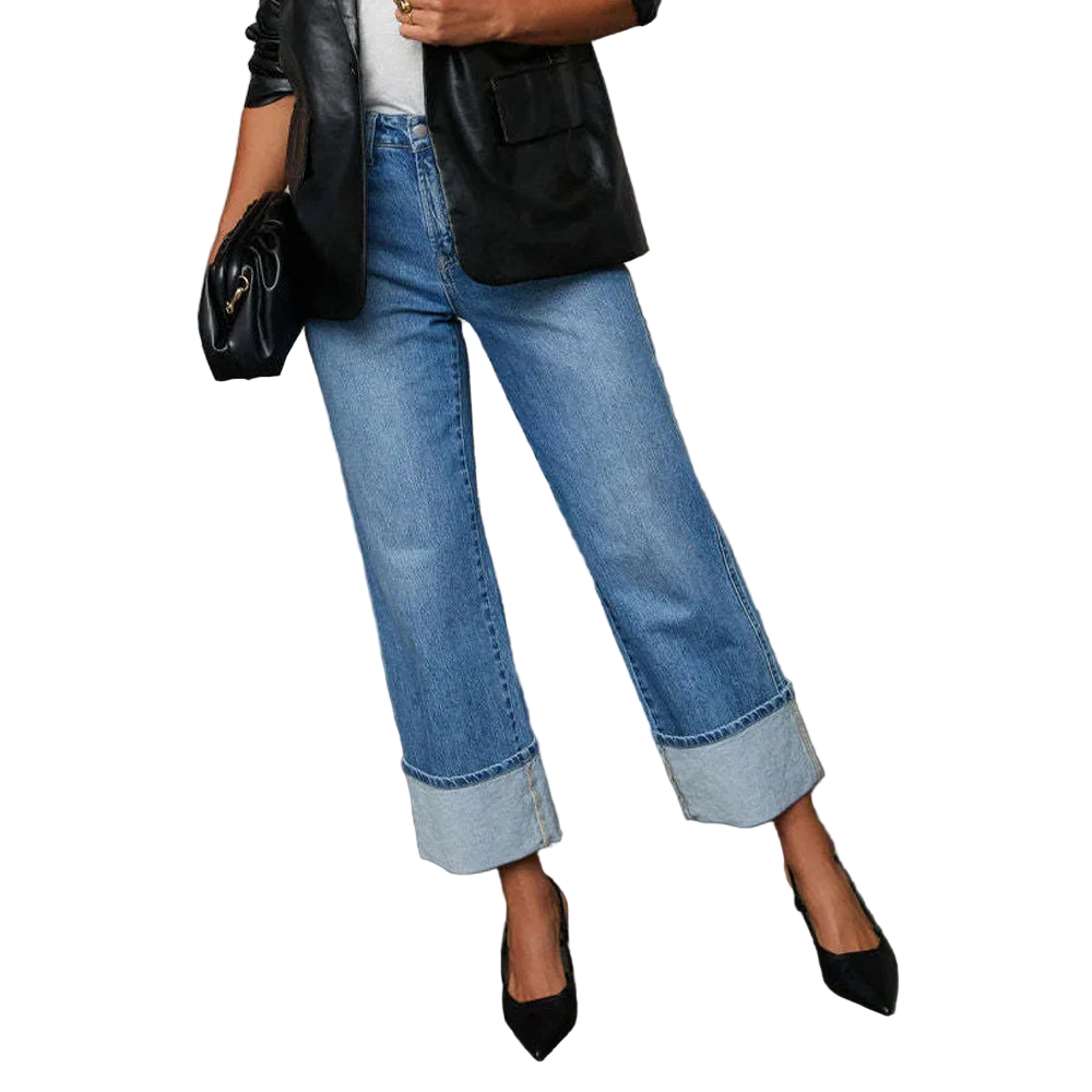 Person wearing blue jeans with a black jacket on a white background